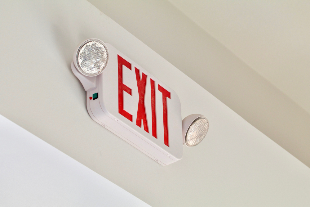 A,red,exit,sign,with,emergency,lights,shows,above,a