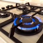 Closeup,shot,of,blue,fire,from,domestic,kitchen,stove,top.
